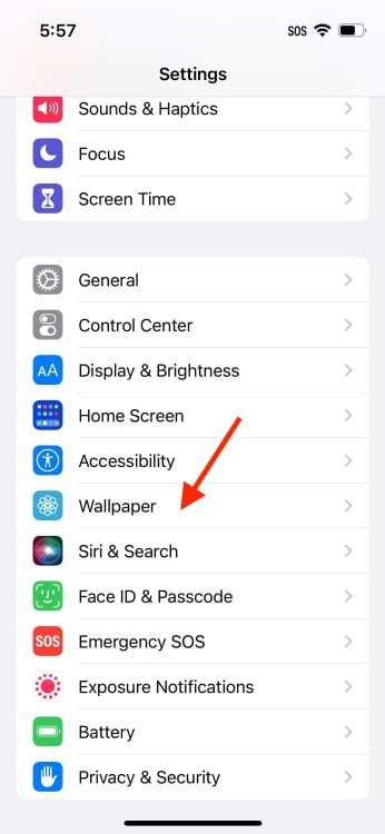 Screenshot of iPhone settings with red arrow pointing to "Wallpaper"